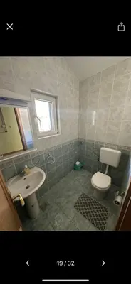 a bathroom with a white toilet and a sink at Njaro Del Mar 18 in Petrovac na Moru