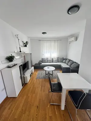 a living room with a couch and a table at City Apartment in Podgorica
