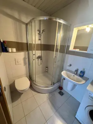 a bathroom with a shower and a toilet and a sink at City Apartment in Podgorica
