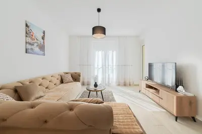 a living room with a couch and a tv at MM Apartments Brown in Budva