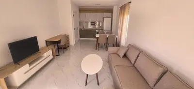 a living room with a couch and a table at Apartmani Banović 3 - Ulcinj, Velika plaža in Ulcinj