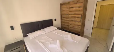 a bedroom with a bed with two towels on it at Apartmani Banović 2 - Ulcinj, Velika plaža in Ulcinj