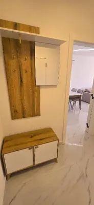 a living room with a table and a mirror at Apartmani Banović 2 - Ulcinj, Velika plaža in Ulcinj