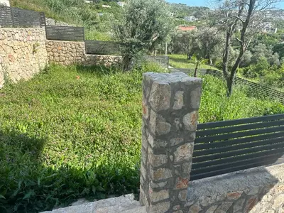 a stone pillar sitting next to a park bench at Villa Zaljevo in Bar