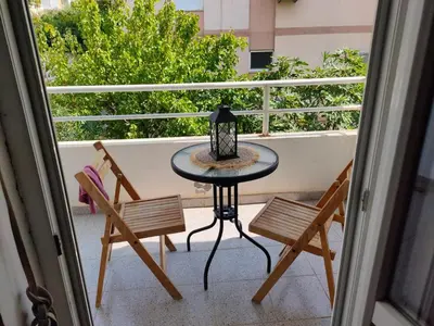 a table and two chairs on a balcony at MiNa Studio Petrovac in Petrovac na Moru