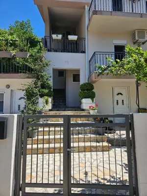 a building with a gate in front of it at Vila Lučica studio pogled na more in Petrovac na Moru