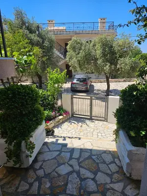 a car parked in a parking lot in front of a building at Vila Lučica apartman pogled na more in Petrovac na Moru