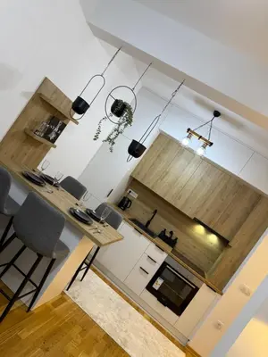 a living room with a table and chairs at Modern flat 5 Min to Beach in Ulcinj