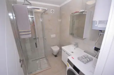 a bathroom with a shower and a toilet and a sink at Studio Dobra Voda 14 in Bar