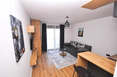 a living room with a couch and a table at Studio Dobra Voda 14 in Bar