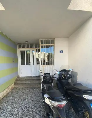 a motorcycle parked in front of a door at Centar, Kosta apartment in Bar
