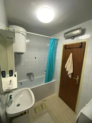 a bathroom with a tub and a sink and a shower at Kosta in Bar