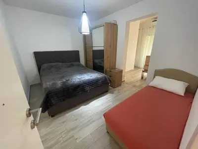 a bedroom with a bed and a mirror at Asijaapartmani in Bar