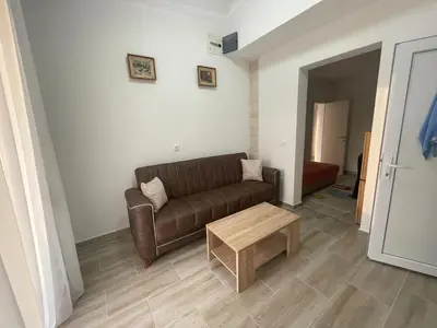a living room with a couch and a coffee table at Asijaapartmani in Bar