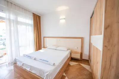 a bedroom with a bed and a large window at Lana Apartments in Ulcinj