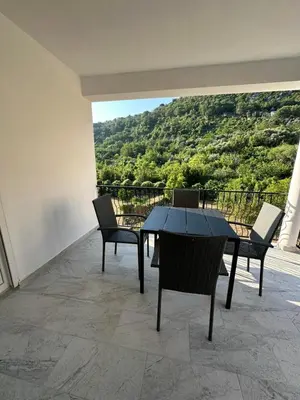 a table and chairs on a balcony with a view at Apartmani Aki 5 in Bar