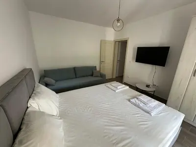 a small bedroom with a bed and a couch at Apartman Aki 2 in Bar