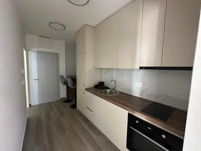 a kitchen with white cabinets and a sink at Apartman Aki 2 in Bar