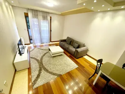 a living room with a couch and a table at CENTRAL apartment in Podgorica