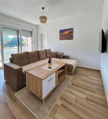 a living room with a couch and a table at Apartman Živaljević 1 Tivat in Tivat
