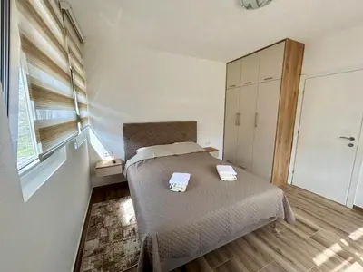 a bedroom with a bed with two towels on it at Apartman Živaljević 1 Tivat in Tivat