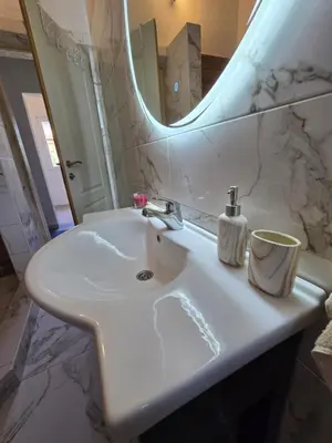 a white sink in a bathroom with a mirror at Penthouse apartman Ogist Velika plaza Long beach near Ada Bojana in Donji Štoj
