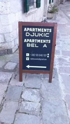 a sign sitting on the side of a street at Balcony with Old Town view in Kotor