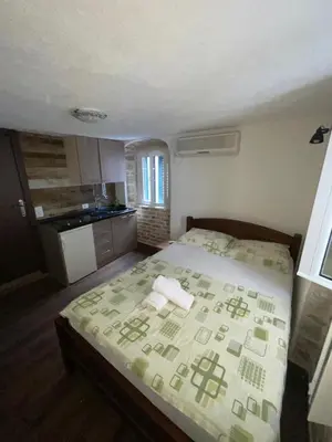 a small bedroom with a bed in a room at sar 5 in Kotor