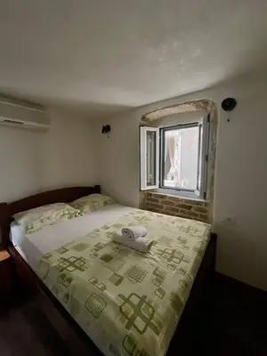 a bedroom with a bed with a phone on it at sar 5 in Kotor