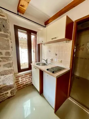 a small kitchen with a sink and a window at Square view in Kotor