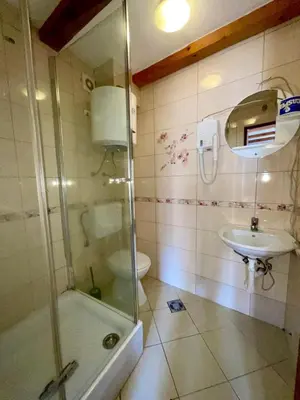 a bathroom with a shower and a sink and a toilet at Square view in Kotor