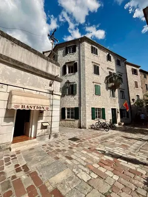 a large stone building with a sign on it at bella 11 in Kotor