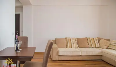 a living room with a couch and a table at Lotos - stan 318 in Dobra Voda