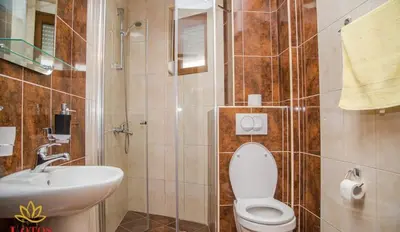 a bathroom with a toilet and a sink at Lotos - stan 423 in Dobra Voda