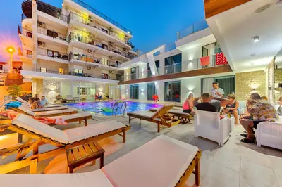 a group of people sitting around a pool in a building at Lotos - stan 212 in Dobra Voda