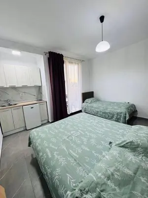 a room with two beds and a kitchen with at SoFi in Ulcinj