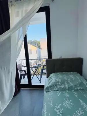 a bedroom with a bed and a view of a balcony at SoFi in Ulcinj