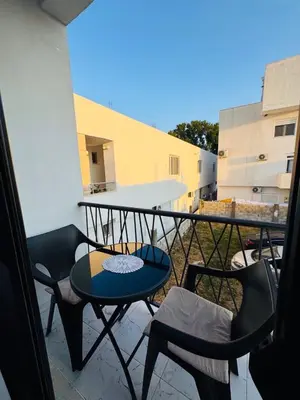 a balcony with a table and chairs on it at SoFi in Ulcinj