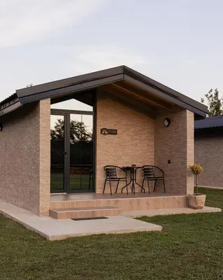 a building with a table and chairs in it at Jelena in Balabani