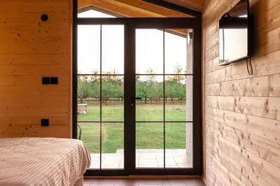 a bedroom with a bed and a large window at Nina in Golubovci