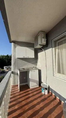 a kitchen with a refrigerator on the side of a building at Apparteman in Ulcinj
