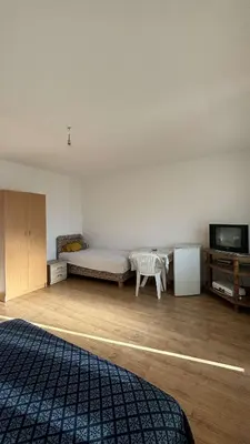 a bedroom with a bed and a tv in it at Apparteman in Ulcinj