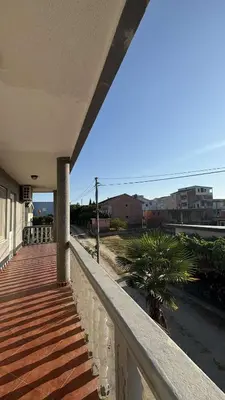 a balcony of a house with a palm tree on it at Apparteman in Ulcinj