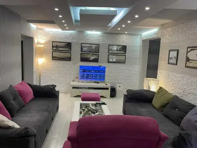 a living room with a couch and a tv at Apart102 in Budva