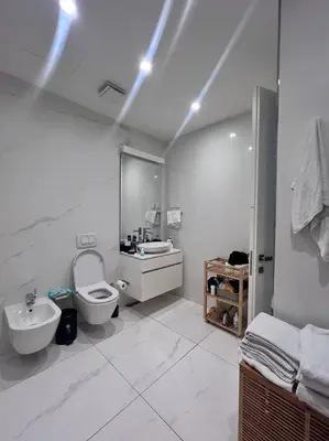 a white bathroom with a toilet and a sink at Dukley Retreat, Serenity Collection in Budva