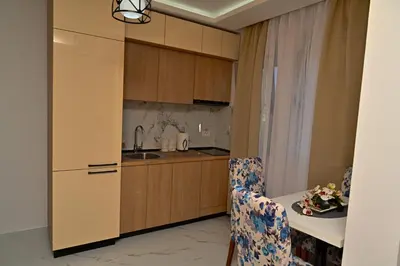 a kitchen with a sink and a table with a chair at Stars Five Stay in Ulcinj
