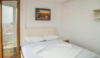 a bed with two white pillows in a room at Lotos - stan 421 L2 in Dobra Voda