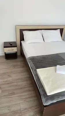 a bedroom with a bed and a nightstand next to it at Revea in Budva