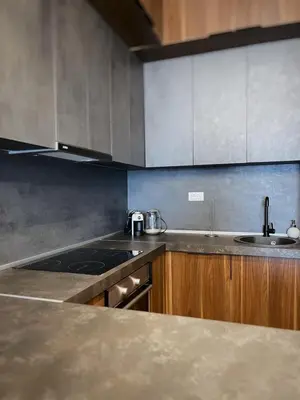 a kitchen with a sink and a stove top oven at Apartman Bulevar in Ulcinj