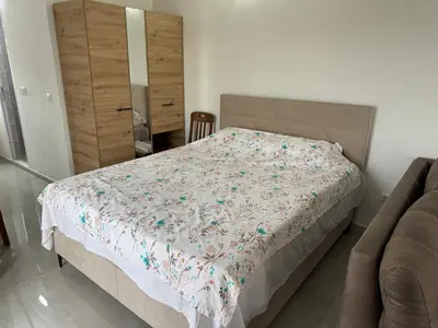 a bedroom with a bed and a dresser at Apartmani in Sutomore